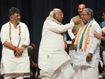 Congress president Mallikarjun Kharge offers sweets to Siddaramaiah during celebrations after the party's win in Karnataka Assembly elections, as state unit chief DK Shivakumar looks on. Congress president Mallikarjun Kharge offers sweets to Siddaramaiah during celebrations after the party's win in Karnataka Assembly elections, as state unit chief DK Shivakumar looks on.
