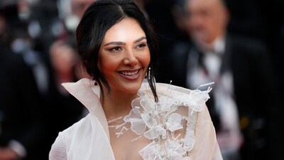 Actor Esha Gupta poses for photographers upon arrival at the opening ceremony and the premiere of the film 'Jeanne du Barry' at the 76th Cannes International Film Festival. For the glam event, she donned &nbsp;a white gown with a thigh-high slit.&nbsp; (AP)