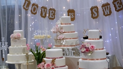 The decorations included a two-tiered white cake with red roses on top, as well as heart-shaped cookies and finger sandwiches in the shape of wedding bells. (REUTERS)