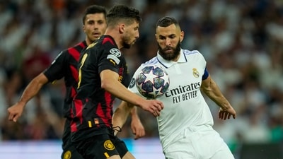 Real Madrid's Karim Benzema, right, duels for the ball with Manchester City's Ruben Dias, front left, during the Champions League semifinal first leg soccer match between Real Madrid and Manchester City at the Santiago Bernabeu stadium in Madrid, Spain, Tuesday, May 9, 2023. (AP Photo/Jose Breton) (AP) Real Madrid's Karim Benzema, right, duels for the ball with Manchester City's Ruben Dias, front left, during the Champions League semifinal first leg soccer match between Real Madrid and Manchester City at the Santiago Bernabeu stadium in Madrid, Spain, Tuesday, May 9, 2023. (AP Photo/Jose Breton) (AP)
