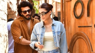 Arjun Kapoor and Kriti Sanon were snapped at One8 Commune restaurant in Juhu, Mumbai. For the outing, Kriti wore a cream top under a denim jacket and pants. Arjun opted for a dark rust shirt and pants. Both of them wore dark sunglasses. Arjun Kapoor and Kriti Sanon were snapped at One8 Commune restaurant in Juhu, Mumbai. For the outing, Kriti wore a cream top under a denim jacket and pants. Arjun opted for a dark rust shirt and pants. Both of them wore dark sunglasses.