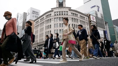 People walk at a pedestrian crossing in Ginza shopping district Friday in Tokyo, Japan. (AP) People walk at a pedestrian crossing in Ginza shopping district Friday in Tokyo, Japan. (AP)