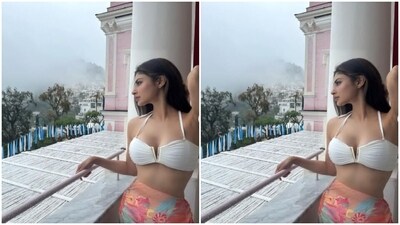 Mouni decked up in a white ruched bralette with a plunging neckline and halter neckline. She further teamed it with a multicoloured satin sarong that came printed in shades of blue, orange and red. (Instagram/@imouniroy) Mouni decked up in a white ruched bralette with a plunging neckline and halter neckline. She further teamed it with a multicoloured satin sarong that came printed in shades of blue, orange and red. (Instagram/@imouniroy)