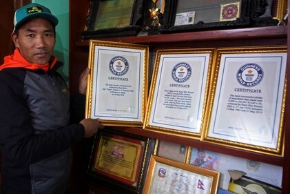 Nepal's mountaineer Kami Rita Sherpa poses with his Guinness World Record certificates inside his rented room at the Boudhanath Stupa area on the outskirts of Kathmandu. (AFP) Nepal's mountaineer Kami Rita Sherpa poses with his Guinness World Record certificates inside his rented room at the Boudhanath Stupa area on the outskirts of Kathmandu. (AFP)