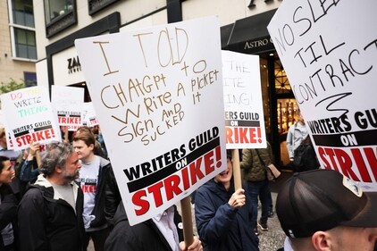 Members of the Writers Guild of America (WGA) East hold signs as they walk on the picket-line outside of the Peacock NewFront on May 02, 2023 in New York City. WGA members were out on the first day of a Hollywood voters strike after the board of directors for the Writers Guild of America, which includes West Coast and East Coast branches, voted unanimously to call for a walkout. (Getty Images via AFP) Members of the Writers Guild of America (WGA) East hold signs as they walk on the picket-line outside of the Peacock NewFront on May 02, 2023 in New York City. WGA members were out on the first day of a Hollywood voters strike after the board of directors for the Writers Guild of America, which includes West Coast and East Coast branches, voted unanimously to call for a walkout. (Getty Images via AFP)