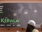 People ride past a poster of a Hindi movie titled "The Kerala Story", outside a cinema in Mumbai. (REUTERS File) People ride past a poster of a Hindi movie titled "The Kerala Story", outside a cinema in Mumbai. (REUTERS File)