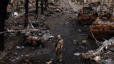 Russia-Ukraine War: A Ukrainian serviceman stands amid destroyed Russian tanks in Bucha, on the outskirts of Kyiv, Ukraine. (AP) Russia-Ukraine War: A Ukrainian serviceman stands amid destroyed Russian tanks in Bucha, on the outskirts of Kyiv, Ukraine. (AP)