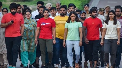 Wrestlers Sakshi Malik, Bajrang Punia, Vinesh Phogat and Sangeeta Phogat visit Rajghat in New Delhi on Thursday. (PTI)