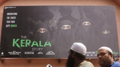 People ride past a poster of a Hindi movie titled "The Kerala Story", outside a cinema in Mumbai. (REUTERS File) People ride past a poster of a Hindi movie titled "The Kerala Story", outside a cinema in Mumbai. (REUTERS File)