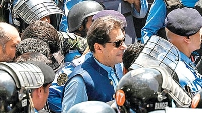 Policemen escort Pakistan's former Prime Minister Imran Khan as he arrives at the high court in Islamabad. (AFP) Policemen escort Pakistan's former Prime Minister Imran Khan as he arrives at the high court in Islamabad. (AFP)