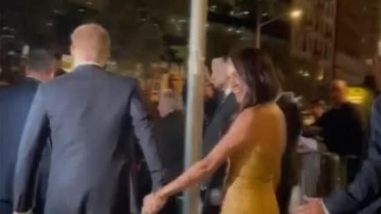 In this image from video, Prince Harry and his wife Meghan exit Manhattan’s Ziegfeld Ballroom on Tuesday, May 16, 2023 in New York. (AP)