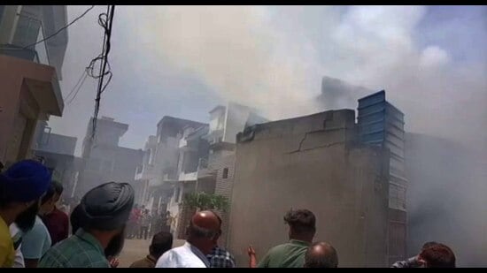 Firefighters trying to douse the flames at a chemical godown in Khanna, Ludhiana, on Thursday. (HT Photo)