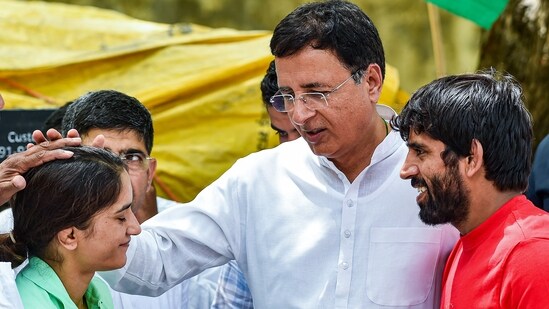 Congress leader Randeep Surjewala with wrestlers Bajrang Punia and Vinesh Phogat during the wrestlers' protest against Wrestling Federation of India chief Brij Bhushan Sharan Singh at Jantar Mantar in New Delhi on Thursday, (PTI)