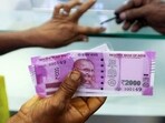 A woman holds <span class='webrupee'>₹</span>2000 notes as she exchanges demonetised notes at a bank in Chennai. A woman holds <span class='webrupee'>₹</span>2000 notes as she exchanges demonetised notes at a bank in Chennai.
