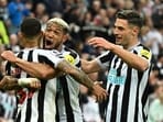TOPSHOT - Newcastle United's Brazilian midfielder Bruno Guimaraes (L) celebrates after scoring his team fourth goal during the English Premier League football match between Newcastle United and Brighton