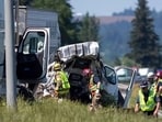 Oregon State Police troopers and firefighters assist in recovering a crash site on Thursday, May 18, 2023, along Interstate 5 in Albany, Ore. (Alex Powers/Albany Democrat-Herald via AP) Oregon State Police troopers and firefighters assist in recovering a crash site on Thursday, May 18, 2023, along Interstate 5 in Albany, Ore. (Alex Powers/Albany Democrat-Herald via AP)