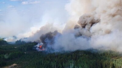Smoke rises above the southeast perimeter of the Paskwa fire (HWF030) as it burns near Fox Lake, Alberta, Canada May 16. (via REUTERS)