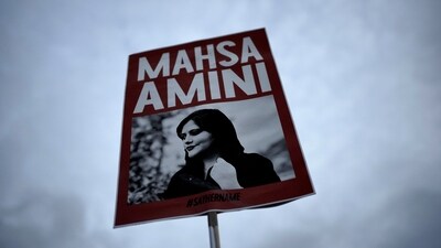 Iran Anti-Hijab Protests: A woman holds a placard with a picture of Iranian woman Mahsa Amini during a protest against her death. (AP) Iran Anti-Hijab Protests: A woman holds a placard with a picture of Iranian woman Mahsa Amini during a protest against her death. (AP)
