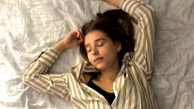 Sleeping on your back with shoulder support: People with rotator cuff pain or shoulder pain should sleep on their back with a small pillow in between their shoulder blades. (Representative Image (Unsplash)) Sleeping on your back with shoulder support: People with rotator cuff pain or shoulder pain should sleep on their back with a small pillow in between their shoulder blades. (Representative Image (Unsplash))