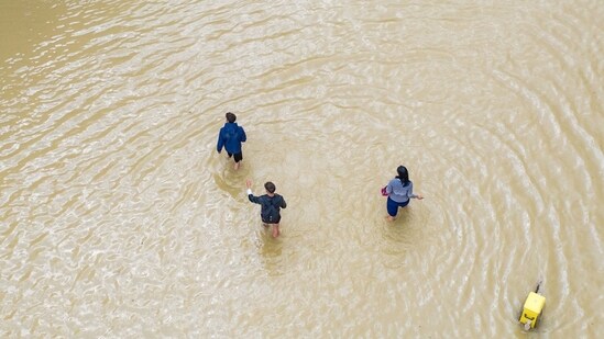 Local residents walk along a flooded street in Lugo, in Ravenna province, northern Italy, on Thursday, May 18, 2023.&nbsp;(Bloomberg)