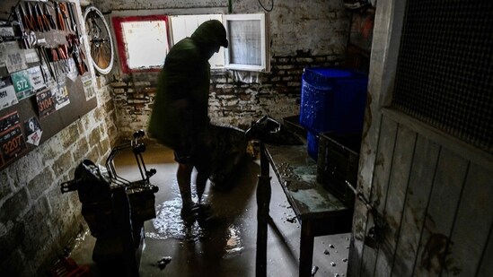 A resident cleans his flooded basement on May 19, 2023 in Faenza, after floodwaters hit the Emilia-Romagna region.&nbsp;(AFP)
