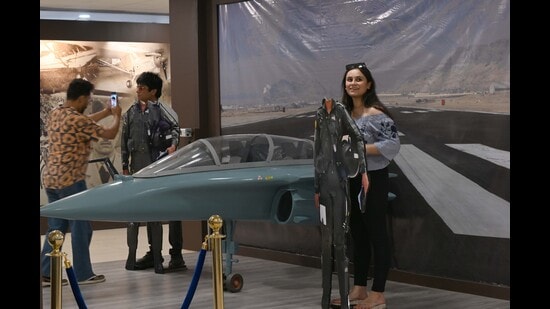 Visitors taking pictures next to exhibits at the Indian Air Force Heritage Centre in Sector 18, Chandigarh. (Ravi Kumar/HT)