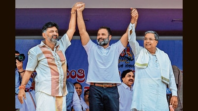 Congress leaders DK Shivakumar, Rahul Gandhi and Siddaramaiah in Bengaluru on Saturday. (AFP) Congress leaders DK Shivakumar, Rahul Gandhi and Siddaramaiah in Bengaluru on Saturday. (AFP)