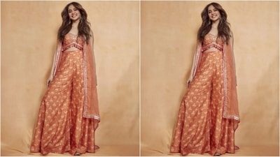 Rakul Preet turned heads in an orange ensemble consisting of a strappy blouse made of tusser silk fabric, embellished with gold sequins, mirrors, and colorful tassels. She paired it with flared silk pants in a matching print, creating a stunning and cohesive look. (Instagram/@rakulpreet) Rakul Preet turned heads in an orange ensemble consisting of a strappy blouse made of tusser silk fabric, embellished with gold sequins, mirrors, and colorful tassels. She paired it with flared silk pants in a matching print, creating a stunning and cohesive look. (Instagram/@rakulpreet)