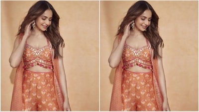 Rakul elevated her look by draping a flowing long cape made of organza fabric. The cape featured silver lace along the border and contemporary prints combining floral motifs with a geometric jaal pattern. (Instagram/@rakulpreet) Rakul elevated her look by draping a flowing long cape made of organza fabric. The cape featured silver lace along the border and contemporary prints combining floral motifs with a geometric jaal pattern. (Instagram/@rakulpreet)