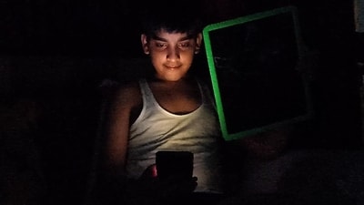 A boy entertaining himself with a smartphone amid a power outage in Mohali on Tuesday. (Ravi Kumar/HT) A boy entertaining himself with a smartphone amid a power outage in Mohali on Tuesday. (Ravi Kumar/HT)