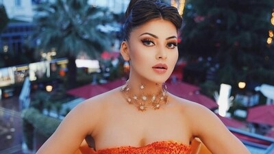 Urvashi Rautela was dressed in an orange gown and wore glamorous hair and makeup. Urvashi Rautela was dressed in an orange gown and wore glamorous hair and makeup. 