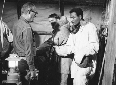 Football player Jim Brown, right, wearing the uniform of a Marine Captain for an upcoming film, Ice Station Zero, where he is directed by John Sturges on Nov. 6, 1967. NFL legend, actor and social activist Jim Brown passed away peacefully in his Los Angeles home on Thursday night, May 18, 2023, with his wife, Monique, by his side, according to a spokeswoman for Brown's family. (AP) Football player Jim Brown, right, wearing the uniform of a Marine Captain for an upcoming film, Ice Station Zero, where he is directed by John Sturges on Nov. 6, 1967. NFL legend, actor and social activist Jim Brown passed away peacefully in his Los Angeles home on Thursday night, May 18, 2023, with his wife, Monique, by his side, according to a spokeswoman for Brown's family. (AP)