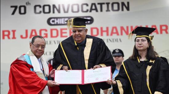 Vice-President Jagdeep Dhankhar, also the chancellor of Panjab University, awarding former Chief Justice of India Ranjan Gogoi (left), who is now a Rajya Sabha member, the honorary degree of Doctor of Literature as vice-chancellor Renu Vig looks on during the 70th convocation ceremony at Panjab University in Chandigarh on Saturday. (Ravi Kumar/HT)