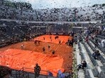 Rain cover is removed form the central court prior to the start of the final match between Denmark's Holger Rune and Russia's Daniil Medvedev at the Italian Open