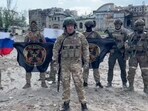 This video grab shows Yevgeny Prigozhin holding a Russian national flag in front of his soldiers holding Wagner Group's flags in Bakhmut. This video grab shows Yevgeny Prigozhin holding a Russian national flag in front of his soldiers holding Wagner Group's flags in Bakhmut.