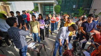 CUET candidates go through a security check before appearing for the exam on Sunday. (Sanchit Khanna/HT Photo) CUET candidates go through a security check before appearing for the exam on Sunday. (Sanchit Khanna/HT Photo)