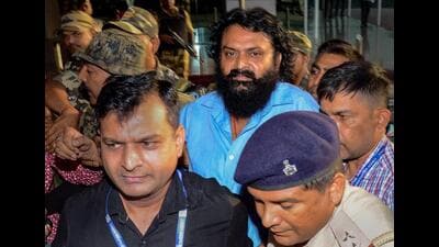 PLFI chief Dinesh Gope being brought after his arrest by NIA, at Birsa Munda Airport in Ranchi, on Sunday. (PTI)