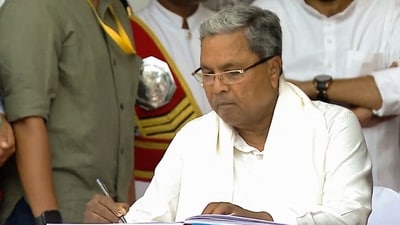 Congress leader Siddaramaiah signs documents after taking oath as Chief Minister, at Bengaluru's Kanteerava Stadium on Saturday, May 20, 2023. (PTI) Congress leader Siddaramaiah signs documents after taking oath as Chief Minister, at Bengaluru's Kanteerava Stadium on Saturday, May 20, 2023. (PTI)