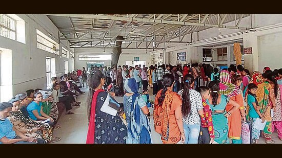 Patient waiting in queues outside the hospital in Ludhiana on Sunday. (HT Photo)