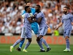 Real Madrid's Vinicius Junior is restrained by Antonio Rudiger and Thibaut Courtois after being sent off