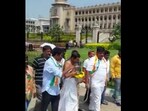 In a video, Congress workers are seen carrying a bucket all around the Karnataka Assembly filled with cow urine and were sprinkling it with leaves.