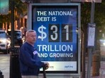 A poster at a bus shelter shows the national debt in Washington, DC. A poster at a bus shelter shows the national debt in Washington, DC.