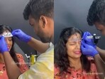 Woman gets inked on the forehead.