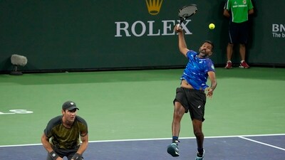 Rohan Bopanna, of India, right, returns a shot next to teammate Matthew Ebden, of Australia, during the men's doubles final against Neal Skupski, of Britain, and Wesley Koolhof, of the Netherlands, at the BNP Paribas Open tennis tournament. (AP)