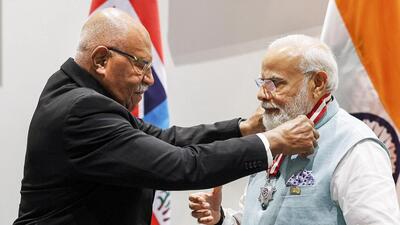 Prime Minister Narendra Modi being honoured with Fiji’s highest honor - the Companion of the Order of Fiji by Fiji PM Sitiveni Rubuka in Port Moresby (PTI/via Twitter @MEAIndia) Prime Minister Narendra Modi being honoured with Fiji’s highest honor - the Companion of the Order of Fiji by Fiji PM Sitiveni Rubuka in Port Moresby (PTI/via Twitter @MEAIndia)