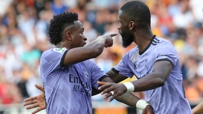 Vinicius Junior (left) confronts Valencia fans as Antonio Rudiger tries to calm him down during a La Liga match (AP) Vinicius Junior (left) confronts Valencia fans as Antonio Rudiger tries to calm him down during a La Liga match (AP)