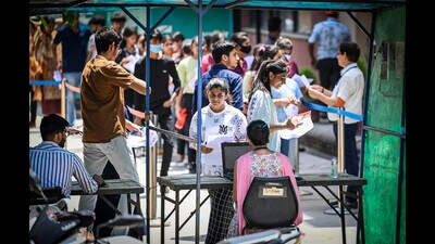 Students arrive to appear for thee Common University Entrance Test for undergraduate admissions (CUET-UG) at an examination centre in New Delhi. (Raj K Raj/ HT)