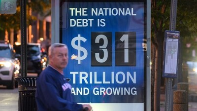 A poster at a bus shelter shows the national debt in Washington, DC, on May 21, 2023. US President Joe Biden will meet with Republican House Speaker Kevin McCarthy on May 22, 2023, for another round of talks on raising the US debt ceiling less than two weeks before a key deadline to avoid a disastrous default, officials said on May 21, 2023. (AFP) A poster at a bus shelter shows the national debt in Washington, DC, on May 21, 2023. US President Joe Biden will meet with Republican House Speaker Kevin McCarthy on May 22, 2023, for another round of talks on raising the US debt ceiling less than two weeks before a key deadline to avoid a disastrous default, officials said on May 21, 2023. (AFP)