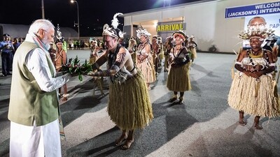 Prime Minister Narendra Modi being accorded a ceremonial welcome upon his arrival in Papua New Guinea on Sunday. A traditional folk dance performance was staged outside the airport to welcome PM Modi to PNG. (PTI) Prime Minister Narendra Modi being accorded a ceremonial welcome upon his arrival in Papua New Guinea on Sunday. A traditional folk dance performance was staged outside the airport to welcome PM Modi to PNG. (PTI)