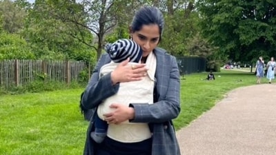 Sonam Kapoor holds son Vayu for a walk outside. Sonam Kapoor holds son Vayu for a walk outside.